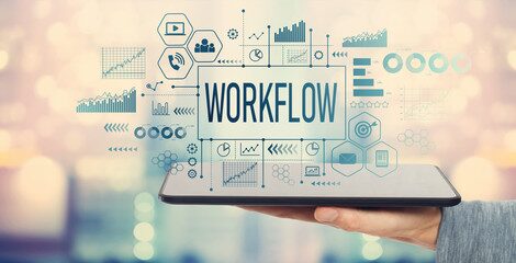 Workflow with man holding a tablet computer